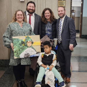 From L to R: Carrie E., Crescent Cove parent, Donovan of Faegre Drinker, Katie Lindenfelser, Crescent Cove executive director and founder, and Nick Zerwas, who helped us with legislative efforts so we could open our home. 