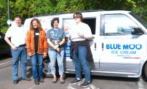 Katie Lindenfelser (second from left) and Jenny Floria (second from right) receive a donation from Delora (far right) and Howard (far left) for the 4th season of the BLUE MOO Ice Cream truck. 