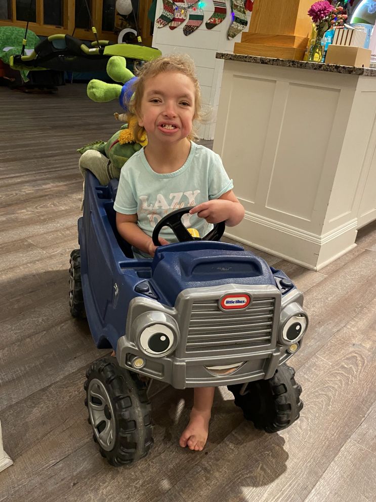 Elsie loves zooming around a toy car at Crescent Cove!