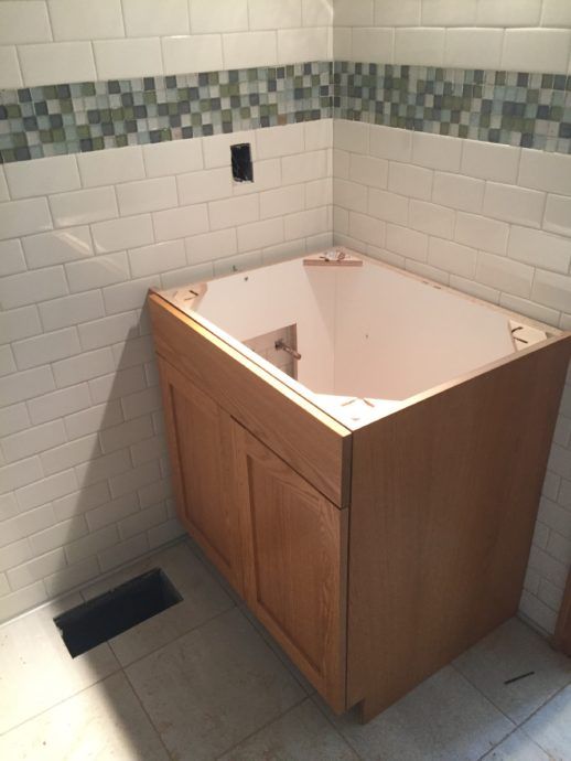 The new vanity in the family suite bathroom just needs a countertop and sink!