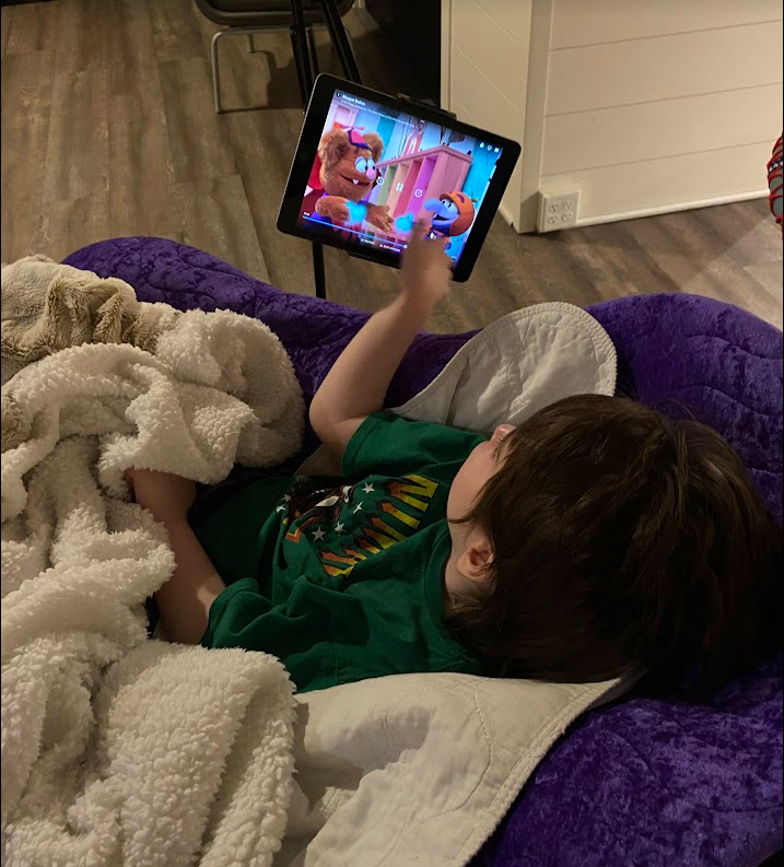 Levi relaxes while watching a show during a respite stay. 